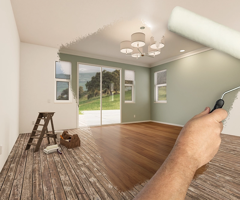 Professional handyman repairing kitchen cabinets with precision tools for home improvement.